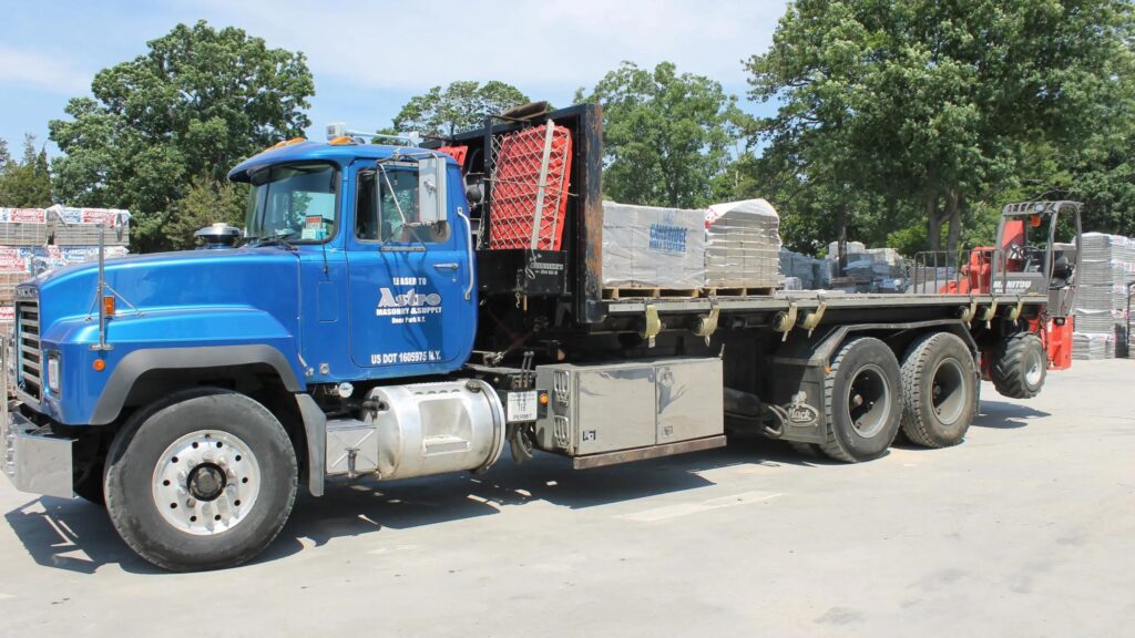 Astro Masonry boom truck delivering masonry materials on Long Island