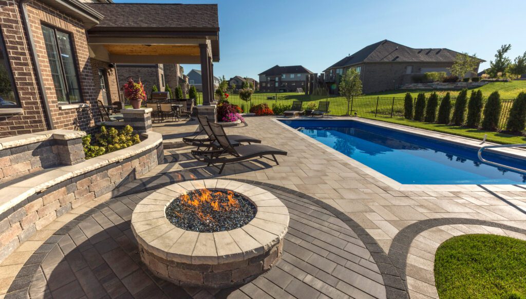 back yard with rectangular pool, patio, fire pit, and lounge chairs